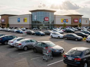 AI generated image of a shopping centre with carpark in the foreground