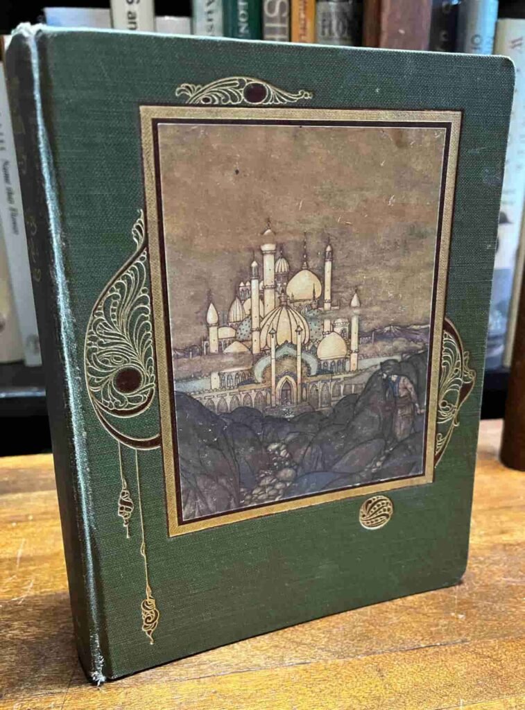 Green hardcover book with an ornate illustration of a palace on the front. The design features decorative gold elements and an intricate border.