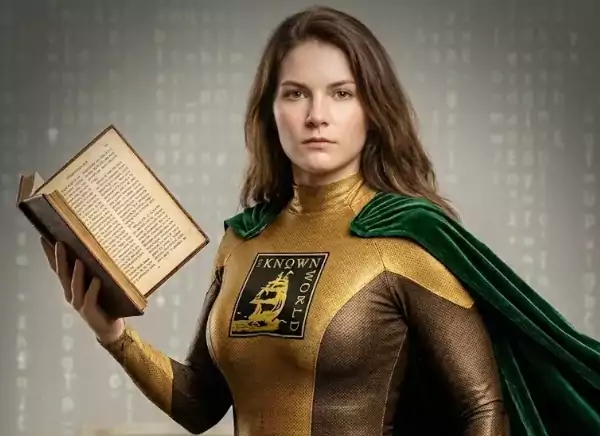 A woman in a superhero costume with a green cape holds an open book